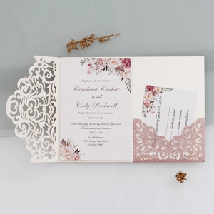 Detail of laser-cut glitter pocket with floral wedding invitation and RSVP card
