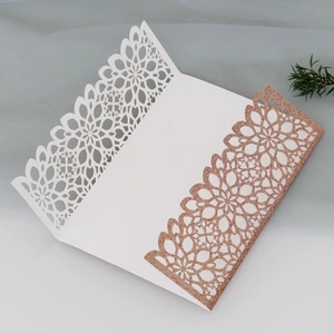 Detailed laser-cut floral pattern on rose gold glitter wedding invitation card cover