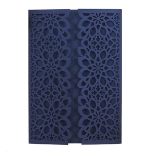 Detail showing laser-cut dark blue floral lace design on elegant wedding invitation cover