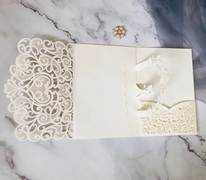 Detailed laser-cut wedding invitation featuring a 3D pop-up arch and pearl brooch ornament