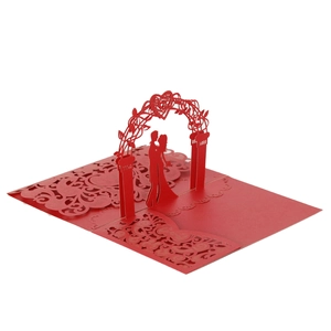 3D laser-cut wedding invitation featuring a romantic couple under a heart arch in red paper