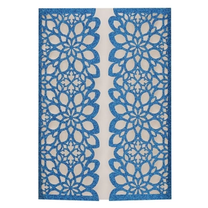 Macro detail of dark blue glitter laser-cut invitation sleeve with mandala floral pattern