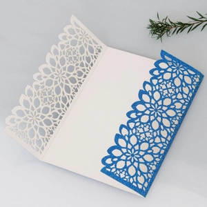 Elegant laser-cut floral wedding invitation card with blue glitter finish and white cover