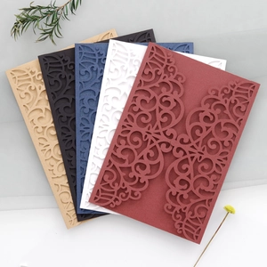 Detail of laser-cut floral patterns on elegant wedding invitation cards in multiple colors