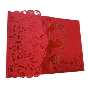 Macro detail of laser-cut red wedding invitation with 3D pop-up silhouette