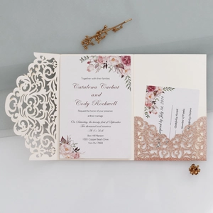 Detail of laser-cut floral wedding invitation set with rose gold glitter insert