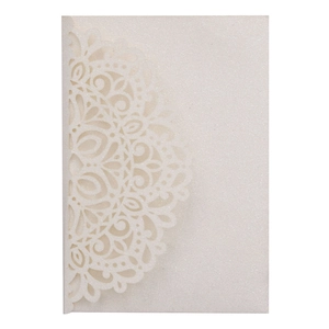 Macro view of laser-cut glitter paper wedding invitation with intricate mandala patterns