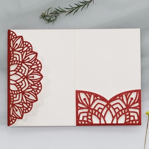 Detailed laser-cut glitter wedding invitation card with elegant red mandala patterns