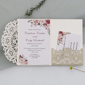 Detail of laser-cut wedding invitation sleeve with floral insert and gold glitter pocket