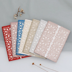 Macro shot of glitter laser-cut wedding invitations showing various colors and textures