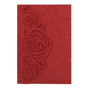 Detail of red glitter wedding invitation cover with laser-cut rose floral texture