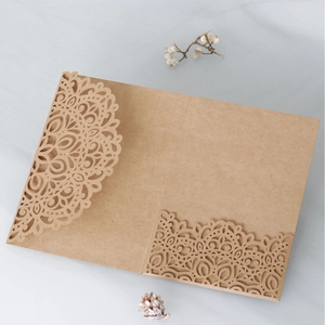 Detailed laser-cut mandala pattern on brown kraft paper wedding invitation envelope