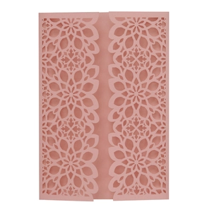 Detail of laser cut flower pattern on dusty rose pink tri-fold wedding invitation cover