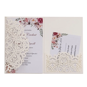 Detailed laser-cut wedding invitation with floral patterns and matching RSVP card