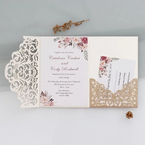 Detail view of laser cut wedding invitation set with glitter pocket and floral cards