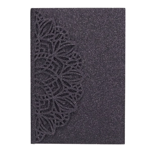 Detail of dark grey glitter invitation card with laser-cut mandala lace pattern