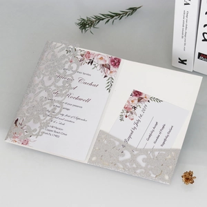 Dettaglio dell'invito di nozze glitter argento tagliato al laser con inserti floreali