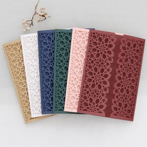 Macro detail of laser-cut mandala patterns on premium pearlescent invitation covers