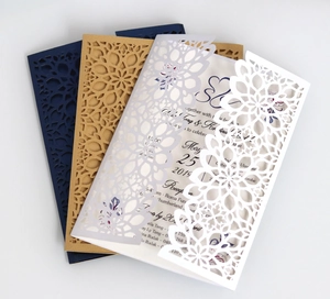 Detail of laser cut mandala hollow wedding invitations in navy, kraft and white options