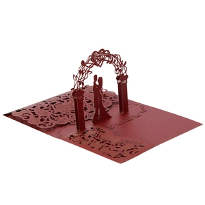 Detail of 3D laser cut wedding card with a burgundy couple silhouette and floral arch