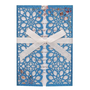 Laser cut blue glitter wedding invitation card with ribbon bow and floral insert