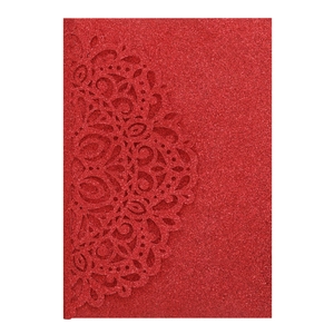Intricate laser-cut patterns on a red glitter wedding invitation card detail