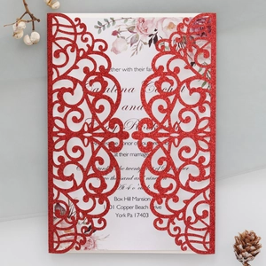 Detailed laser cut red glitter wedding invitation with elegant floral and vine patterns