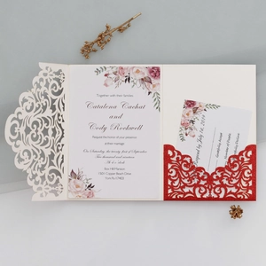 Detail of laser-cut glitter wedding invitation with watercolor floral pattern and RSVP card