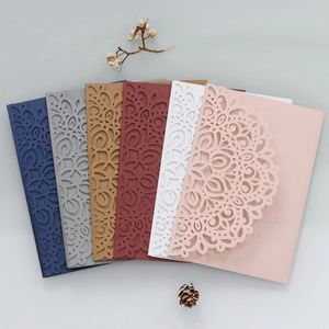 Detailed view of laser-cut floral wedding invitation covers in six elegant colors