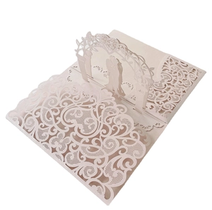 Close-up of laser-cut 3D pop-up wedding invitation featuring a romantic archway
