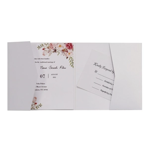 Detailed view of white gate-fold wedding invitation with pink floral watercolor elements