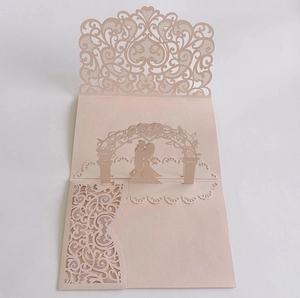 Detailed laser-cut 3D pop-up wedding invitation featuring a bride and groom kissing