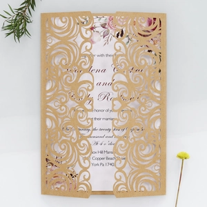 Laser-cut floral brown wedding invitation card with white floral inner sheet and envelope