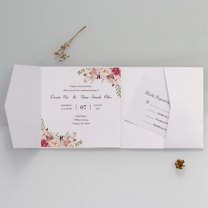 Detailed view of floral wedding invitation suite with RSVP card and white pocket folder