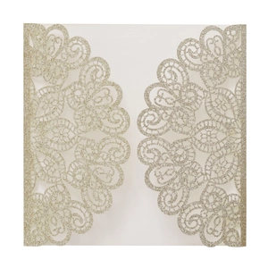 Detail of champagne gold laser-cut lace wedding invitation with glitter texture