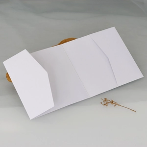 Detail of white tri-fold wedding invitation card holder with inner diagonal pockets