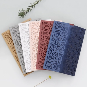 Detail of laser-cut wedding invitation shells in multiple colors with floral patterns