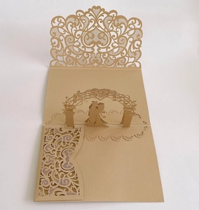 Detailed close-up of 3D laser-cut wedding invitation featuring a couple in heart arch