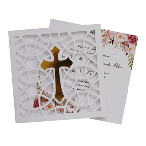 White laser cut baptism invitation card featuring a gold mirror cross and floral interior