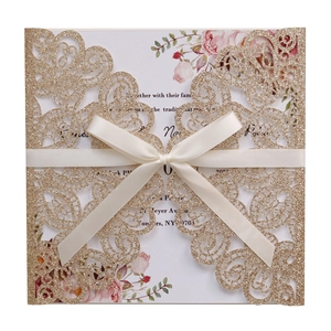 Champagne glitter wedding invitation with laser-cut lace and cream satin ribbon