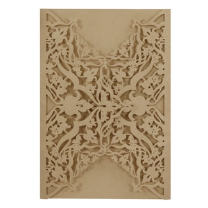 Detail of laser-cut floral pattern on champagne gold pearlescent paper wedding invitation