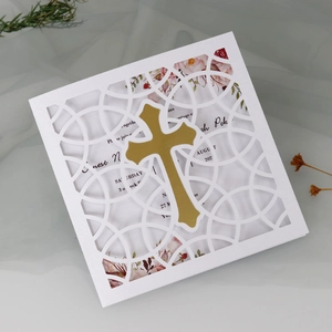 Elegant white laser-cut invitation card with golden cross and floral inner page