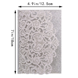 Detail view of silver glitter laser cut wedding invitation with 12.5x18cm dimension markings