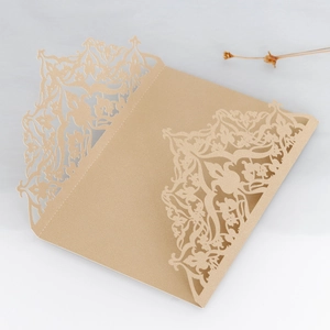 Macro shot of gold laser-cut invitation cover with intricate floral pearl paper pattern
