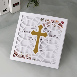 Elegant white laser-cut invitation card with golden cross and floral inner page