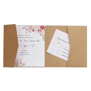 Close-up of rustic kraft wedding invitation suite with floral patterns and RSVP card