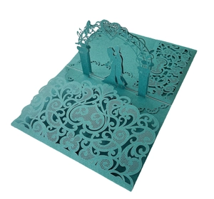 Macro detail of 3D laser-cut wedding card featuring a romantic couple silhouette