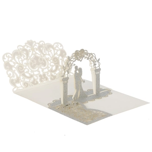 Macro detail of 3D laser-cut wedding card featuring silver glitter and pop-up heart arch