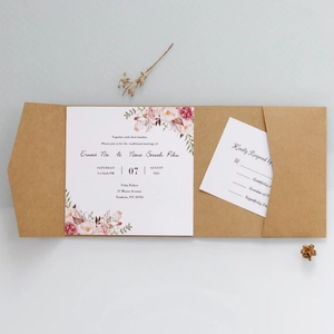 Close-up of minimalist wedding invitation set with floral design and kraft pocket
