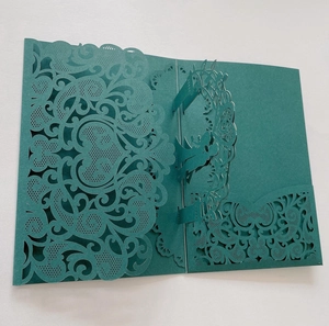 Macro detail of laser-cut 3D pop-up wedding invitation in premium dark teal cardstock